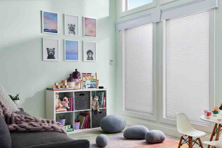 White window shades on windows in a green family room