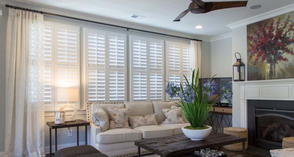 Polywood shutters in a living room with flowers